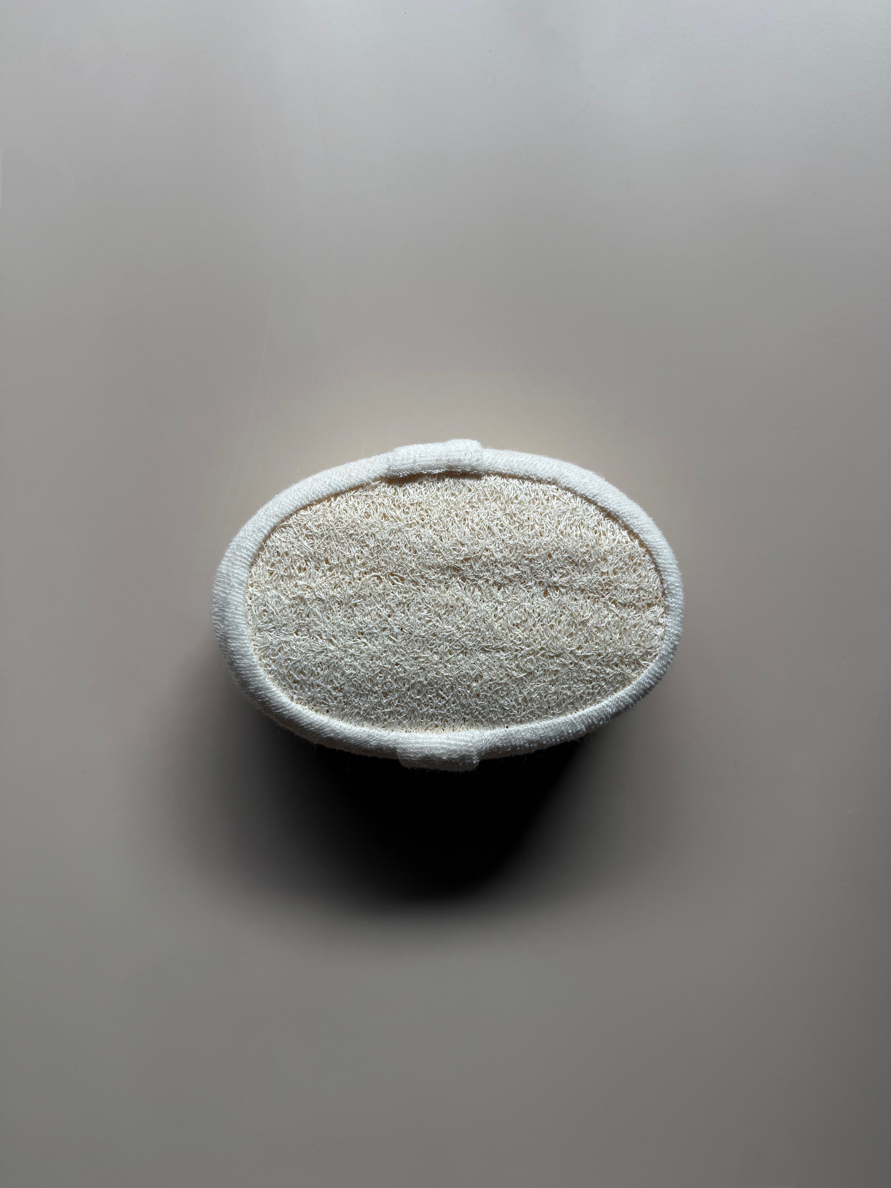 Oval-shaped object with textured surface on a gray background